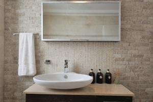 a bathroom with a white sink and a mirror at Alkion Villa Sea View, Olive Tree Garden & Spacious Terrace in Rhodes Town +12 photos