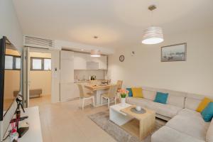 a living room with a couch and a table at Ralux apartman Tivat in Tivat