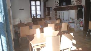 a room with tables and chairs in a room at Rest'ô Bar Les 2 Ponts in Saint-Simon