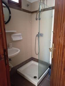 a shower with a glass door in a bathroom at Kalama Apartments in Kalamos +80 photos