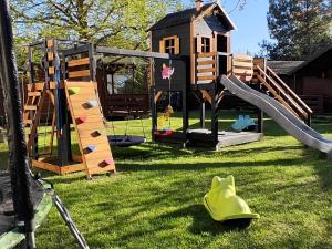 a playground with a slide and a play house at Jaskolcze Gniazdo in Dziwnówek