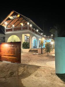 a building with a wooden door in front of it at Nilah Private Pool Villa in Kappil