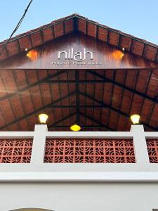 awning of a building with a sign on it at Nilah Private Pool Villa in Kappil