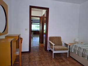 a bedroom with a bed and a chair and a desk at Residence Napoleon - MV in Procchio