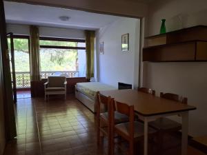 a room with a bed and a table and chairs at Residence Napoleon - MV in Procchio +5 photos