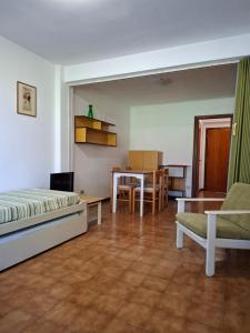 a bedroom with a bed and a table and chairs at Residence Napoleon - MV in Procchio