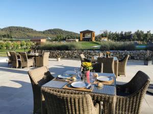an outdoor table with chairs and a table set for dinner at La petite plaine in Clansayes