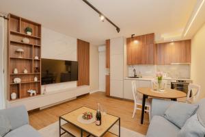 a living room with a couch and a table at Ralux apartman Tivat in Tivat