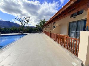 a walkway next to a house with a swimming pool at The Horse Farm Hotel in Kyrenia