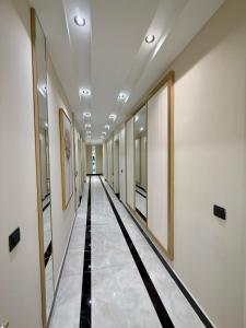 a hallway with a long hallway with paintings on the walls at SA Apartments! Luxury 2BR with Private Beach Access in Alanya