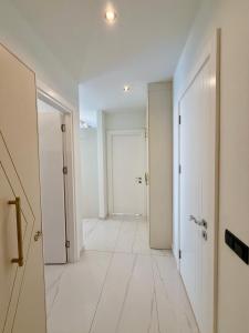 an empty hallway with white walls and a door at SA Apartments! Luxury 2BR with Private Beach Access in Alanya