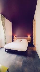 a large white bed in a room with purple ceilings at Descazeaux in Bordeaux