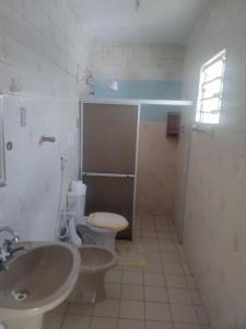 a bathroom with a toilet and a sink at Doce lar do Ipase in São Luís +31 photos