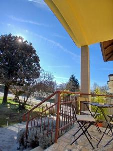 a deck with a table and chairs on a porch at Casa La V G in Almese
