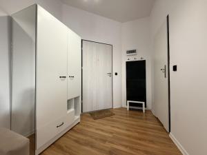 an empty room with white walls and a mirror at w Centrum in Inowrocław