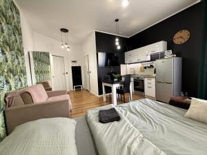 a living room with a bed and a kitchen at w Centrum in Inowrocław