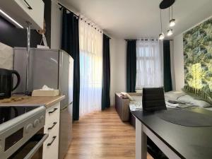 a kitchen with a refrigerator and a couch in a room at w Centrum in Inowrocław