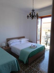 a bedroom with two beds and a chandelier at The Shamrock House in Palazzolo Acreide