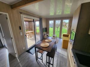 a small room with a table and chairs in a house at La cabane des folies in Montmédy +12 photos