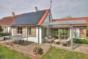 a house with solar panels on the roof at The River Cottage in Middelkerke