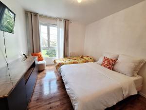 a small bedroom with a bed and a window at Studio ALPHA - non-smoking studio - 3min by train to Disney OR 30min walk - 5min walk to "Val d'Europe" train station in Montévrain