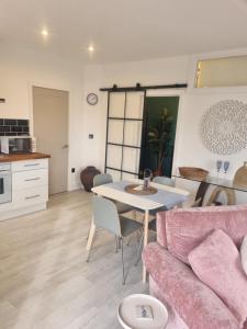 a living room with a table and a couch at Halwyn View in St Austell +16 photos