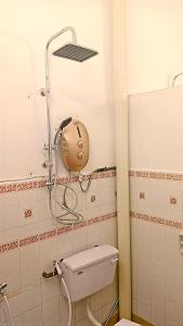 a bathroom with a toilet with a shower head at A K Homestay in Sungai Petani +19 photos