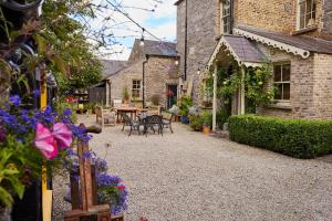 a courtyard of a house with a table and flowers at Preston House in Abbeyleix