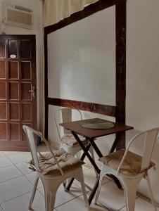 a table and chairs in a room with a table at Pousada Porto Búzios in Búzios
