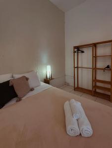 a bedroom with a large bed with two towels on it at Pousada Porto Búzios in Búzios