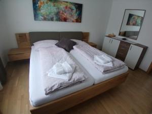 a bedroom with a bed with towels on it at Ferienwohnung Josef in Steyr