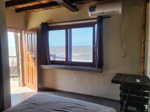 a bedroom with a window with a view of the ocean at Ocean View Riohacha in Ríohacha +40 photos