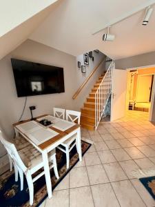 a dining room with a table and a tv at Strandbrise App 17 in Neuhaus +28 photos