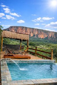 a swimming pool with a view of a mountain at Sertão do Luar in Jurubeba