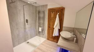 a bathroom with a sink and a toilet and a tub at The Vineyard in Fowey +29 photos