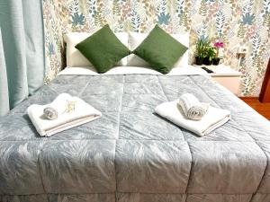 a bed with towels and pillows on it at Vittorio Central Park Guest House in Rome