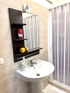 a bathroom with a sink and a mirror at Vittorio Central Park Guest House in Rome +53 photos