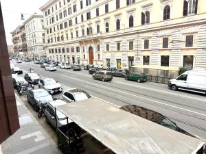 a view of a city street with cars parked on the road at Vittorio Central Park Guest House in Rome