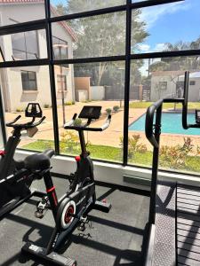 a gym with a bike in front of a window at SouthSide Apartment in Gaborone