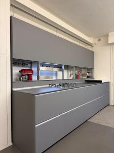 a kitchen with a counter with a stove top oven at Cortirola luxury apartment in Pesaro