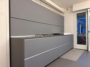a kitchen with white walls and a counter top at Cortirola luxury apartment in Pesaro