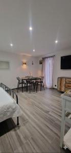 a room with two tables and a television in it at Chez fina in Ath