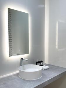 a white bathroom with a sink and a mirror at Silver Bay Kamadhoo in Kamadhoo +45 photos