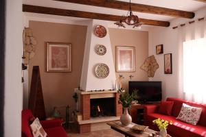 a living room with a red couch and a fireplace at Casa Luce in Caltabellotta