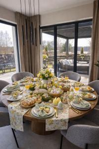 a long table with food on it in a dining room at Oaza Radęcin in Woldenberg Neumark