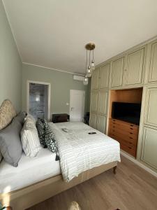 a bedroom with a large bed and a tv at Brugnoli 13 Guest House in Bologna