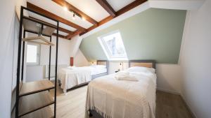 a bedroom with two beds and a window at CharmÖHR Homes in Öhringen