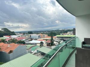 a view of a city from the balcony of a building at Charming Two Bedroom with balcony in San José