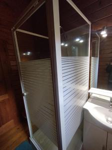 a glass shower in a bathroom with a toilet at chalets bois 150m de la plage in Olmeto +25 photos