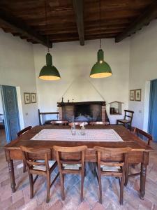 a dining room with a large wooden table and chairs at Casale delle Querce in Amelia